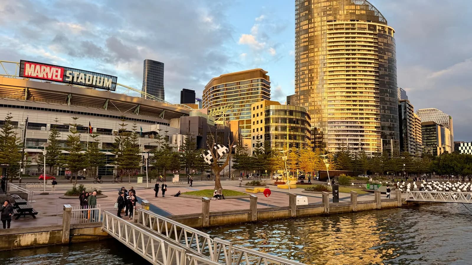 Melbourne's Docklands and Marvel Stadium in golden evening light.