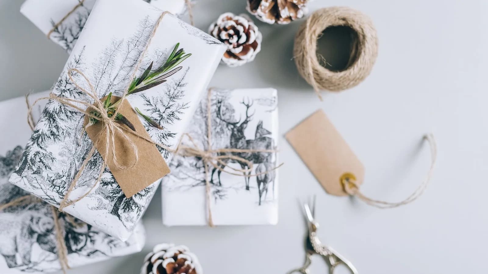 Christmas presents and wrapping materials arranged on a table.