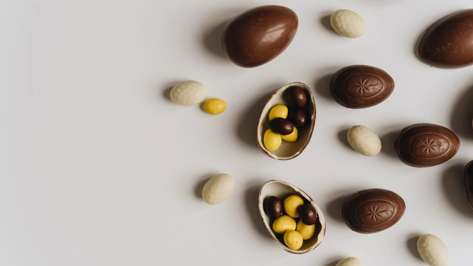 Chocolate Easter eggs arranged on a light background.