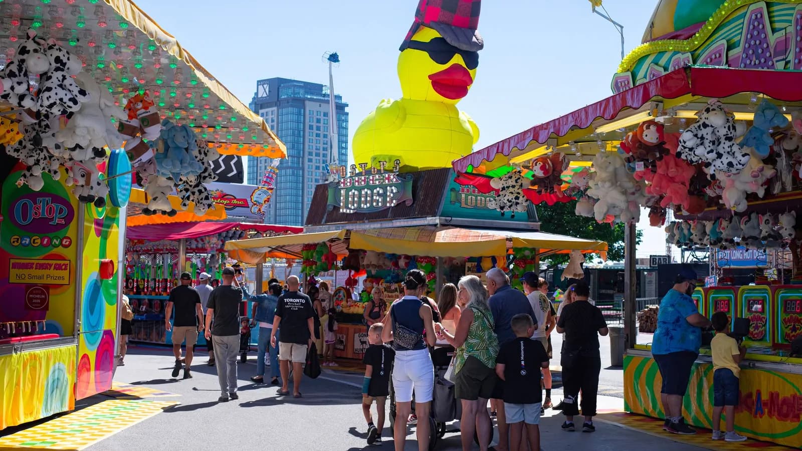 Colourful fairground stalls and a giant yellow duck display.