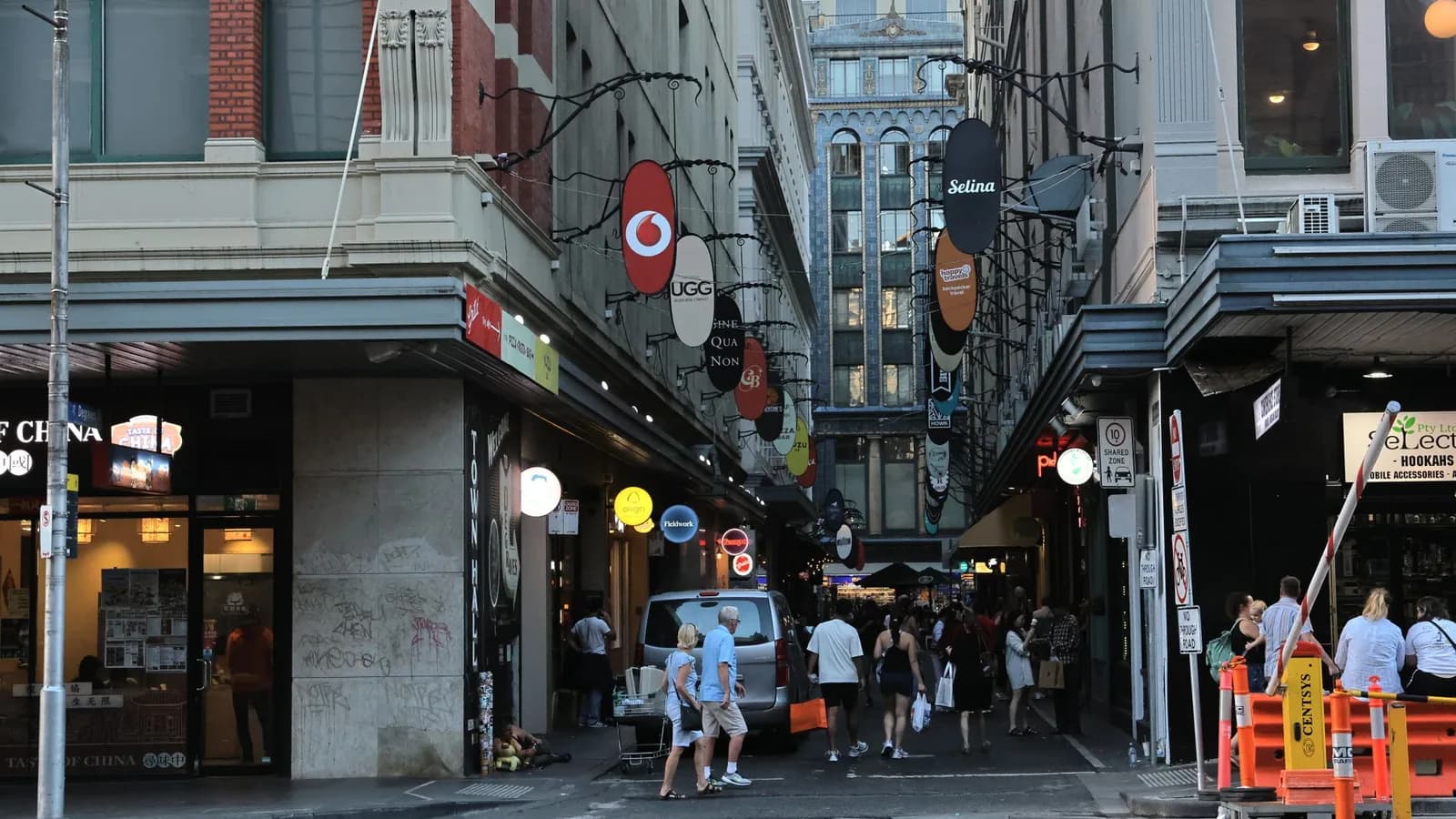 A Melbourne shopping laneway lined with shops and signs.