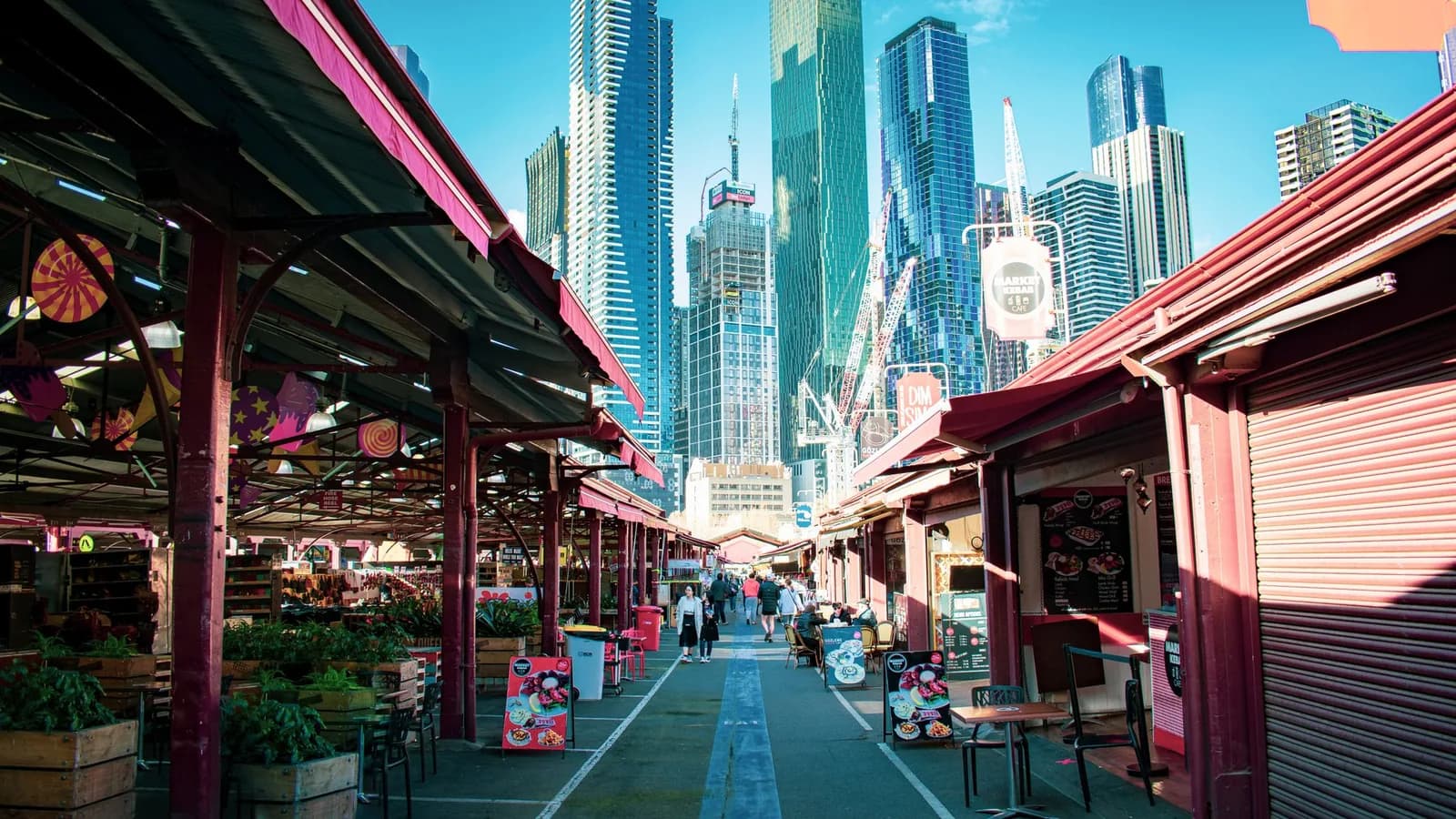 Shopfronts and pedestrians at Melbourne's Queen Victoria Market.